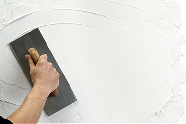 Hand with plastering trowel