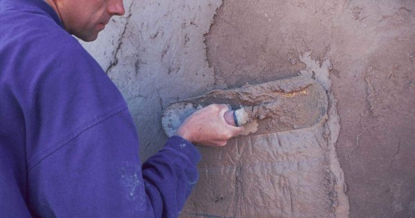 Hand with plastering trowel